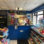 inside view of shop front with aisles of snacks